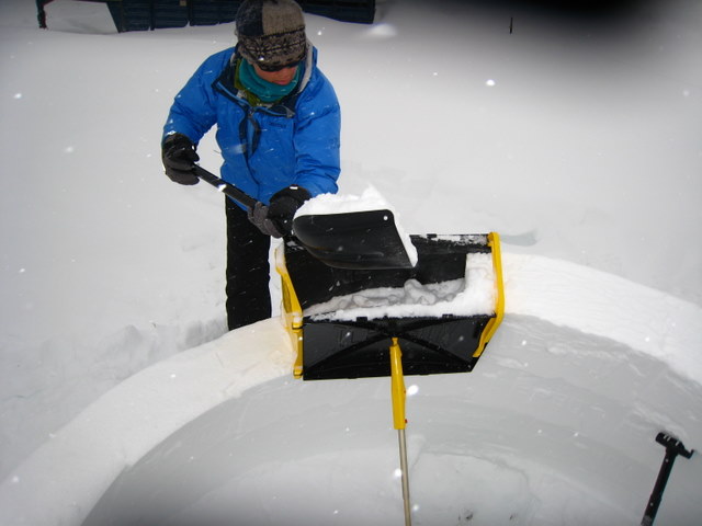 Packing igloo form with snow